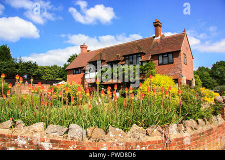 English Country Cottage und Bauerngarten mit Blumen Red Hot Poker Kniphofia bei Tichfield in der Nähe von Fareham England Großbritannien Stockfoto