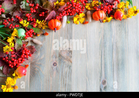 Herbst Hintergrund mit saisonalen Herbst Natur Beeren, Kürbisse, Äpfel und Blumen auf der Holz- Hintergrund. Herbst Konzept Stockfoto