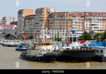 Rumänien, Tulcea an der Donau, Saint George Zweig, Tulcea County, Dobrudscha, Tor zum Donaudelta, Blick auf die Stadt, Hafen, business Häuser und Wohnanlagen, Mehrfamilienhäuser, Wohnblocks, Donauufer, Riverwalk, Schiffsanlegestelle, Schiffe, Boote, Donau Navigation Stockfoto