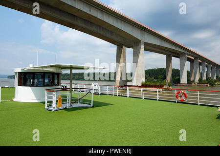 Tourismus, Urlaub, Freizeit, Donau Kreuzfahrt, Donau Navigation, aROSA 393 Mia, upperdeck, Geländer, Rettungsring, Kapitänshaus, Donau Landschaft, Fluss Landschaft in der Nähe von Beska in Serbien, Provinz Vojvodina, Bezirk Srem, Gemeinde Indija, Beska Brücke, Donaubrücke, autobahnbrücke der Europäischen Route 75 Stockfoto