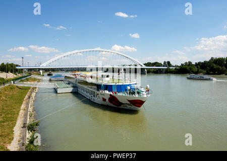 Slowakischen Republik, Slowakei, Bratislava, Hauptstadt, Donau, Kleine Karpaten, Donauufer, Donau Riverwalk, Cruiser aROSA Mia an eine Schiffsanlegestelle, Donau Kreuzfahrt, Donau Navigation, Flusslandschaft, hinter dem Apollo Brücke, Donau Brücke, Straßenbrücke Stockfoto