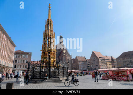 Das 14. Jahrhundert Brunnen Schöner Brunnen auf dem Hauptplatz von Nürnberg, Deutschland. Dahinter steht die Frauenkirche. Stockfoto