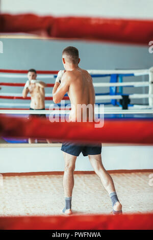 Zurück Blick auf männliche Boxer tun Schattenboxen sport Konzept in der Turnhalle. Stockfoto