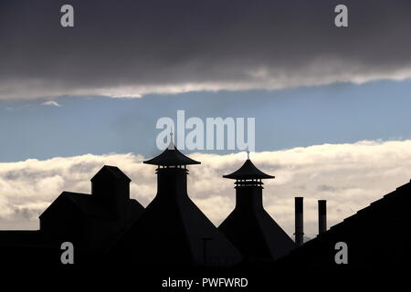 Die zwei brennöfen in der Highland Park Destillerie auf Orkney, Schottland, mit ihren unverwechselbaren Pagode-förmigen Caps gegen den blauen Himmel ab, Wolken. Stockfoto