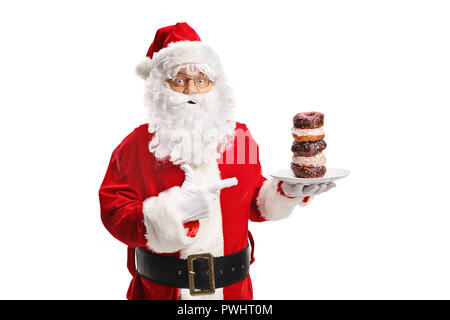 Santa Claus hält einen Teller mit Donuts und zeigt auf weißem Hintergrund Stockfoto