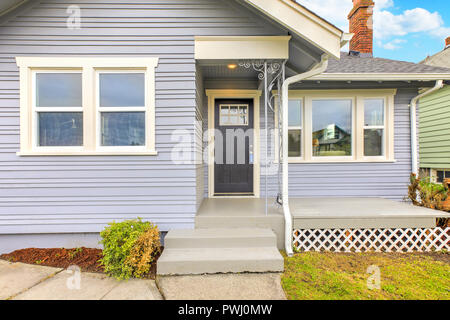 Eingang eines charmanten Blue Home mit dunklen Tür. Stockfoto