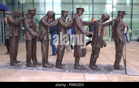 Manchester, Großbritannien. 16. Oktober, 2018. Kennzeichnung der 100-Jahrfeier der zum Ende des ersten Weltkrieges, eine Statue von sieben Soldaten geblendet hat vor dem Haupteingang des Bahnhof Manchester Piccadilly vorgestellt worden. "Sieg über Blindheit' wurde es von der militärischen Liebe blind Veteranen UK in Auftrag gegeben. Die ursprüngliche Skulptur wurde von Künstler und Bildhauer Johanna Domke-Guyot konzipiert. Credit: Terry Waller Alamy leben Nachrichten Stockfoto