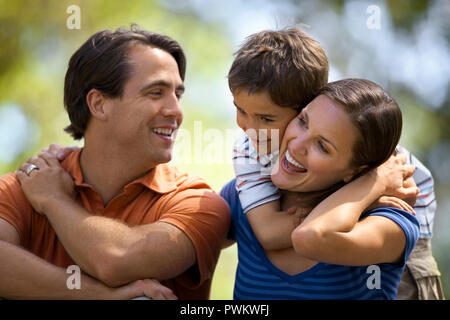 Glückliches Paar mit ihrem jungen Sohn in den Park. Stockfoto