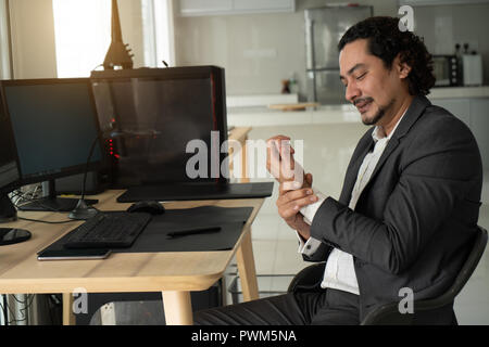 Schöner arabischer Mann Leiden vom Handgelenk Schmerzen in Büro, Nahaufnahme Stockfoto