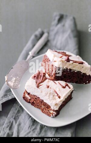 Brownie mit Vanille Creme Mousse auf einem weißen Teller Stockfoto