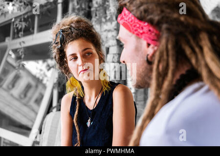 Curly Frau mit Haar bun ihr Freund beim Sprechen über Ihren Tag Stockfoto