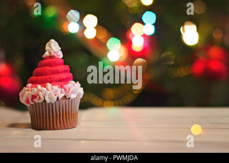 Cupcakes als Weihnachtsmänner" hat eingerichtet, für Weihnachten, gegen bunte bokeh Hintergrund; Urlaub Hintergrund Stockfoto