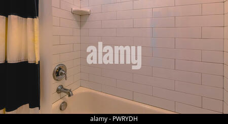 Badezimmer mit Badewanne und weiß gefliesten Wand Stockfoto