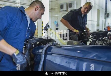 Us Air Force Senior Airman Tyler Odin und Airman 1st Class Kenneth Velez, 18 Mission Support Group Fahrzeug Betreuer, Teile auf einem 18 Sicherheitskräfte Squadron Lkw in der Wartung des Fahrzeugs shop Juni 21, 2017 ersetzen, bei Kadena Air Base, Japan. Fahrzeug Wartungstechniker sicherzustellen, dass Fahrzeuge gewartet und repariert werden, damit die Arbeit sicher Fahrzeuge von Kadena Personal verwendet werden können. Stockfoto