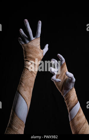 Spooky Mumie Stretching bis Hände gewickelt in Bandagen, Halloween Stockfoto