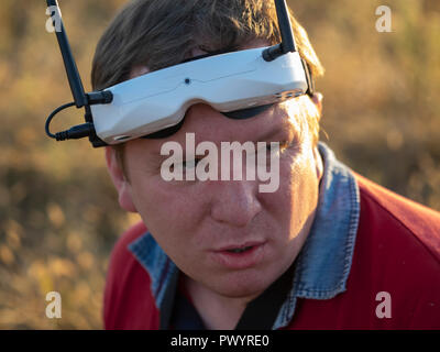 Drone Pilot das erste Mal tragen - Person anzeigen Headset. Junger Mann, der ein Quad-copter mit Video - Schutzbrille Stockfoto