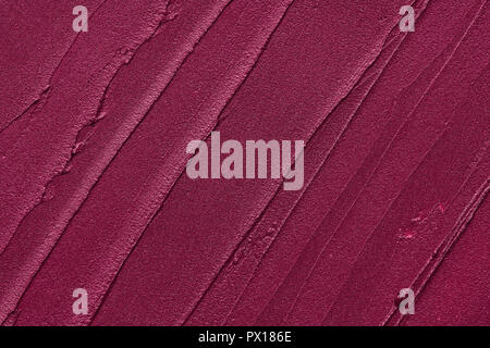 Rote Make-up verschmiert von Lip Gloss Hintergrund. Gebrochene rot creme lipstick Textur Hintergrund Stockfoto