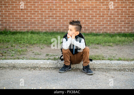 Ein Kind Junge auf dem Schulhof Stockfoto