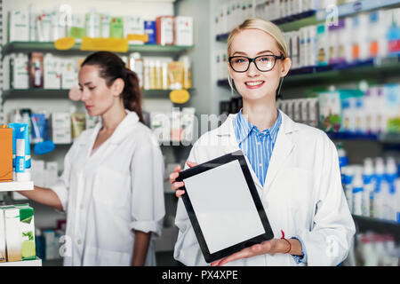 Junge Frau Apotheker hält ein Tablet-PC Stockfoto