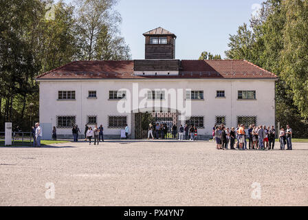 Der Eingang/Ausgang ins Konzentrationslager Dachau in Deutschland mit begleitenden Touristen/Besuchern. Stockfoto