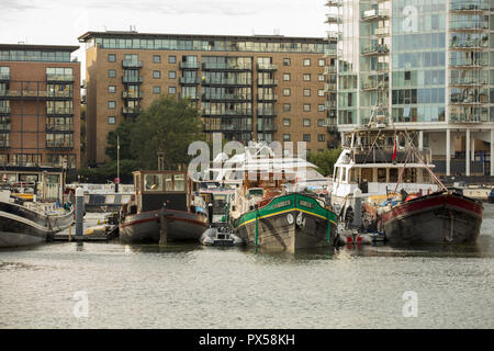 Binnenschiffe und größere Boote sicher an die Verankerungen von der ruhigen und friedlichen Limehouse Basin, London, UK in der Nähe der Themse im Oktober befestigt Stockfoto