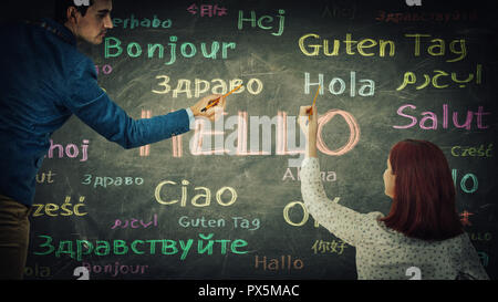 Der Mann und die Frau zu Wort Hallo in verschiedenen Sprachen und Farben auf der Tafel. Gelegenheit für viele Sprachen Lernen für Schüler. Busin Stockfoto