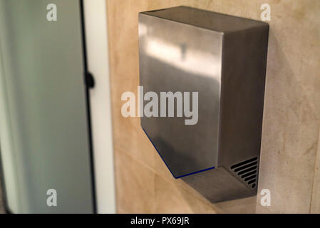 Händetrockner an der Wall in der öffentlichen Toilette, Nahaufnahme Stockfoto