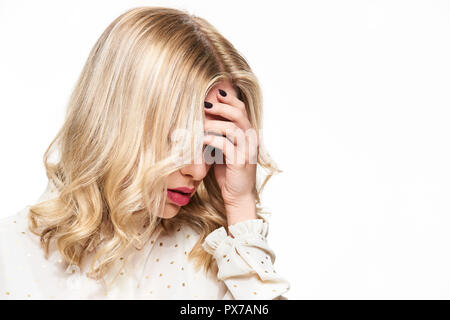 Erschöpft Junge weibliche In starke Spannung Kopfschmerzen betont. Gefühl Druck und Stress. Deprimiert Frau mit Kopf in den Händen Über weißen Hintergrund. Stockfoto