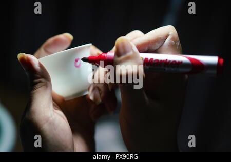 Yuhang, der chinesischen Provinz Jiangxi. Okt, 2018 19. Ein Handwerker namens Wang Minhui macht eine Markierung auf dem Körper eines unqualifizierten fertig Eierschale Porzellan in Jingdezhen, im Osten der chinesischen Provinz Jiangxi, am Okt. 19, 2018. Eggshell Porzellan, einer der traditionellen Porzellan in "Chinas Porzellan Kapital" Jingdezhen hergestellt, verfügt über einen Papery und durchsichtigen Porzellan Körper. Mit zehntausenden von komplizierten rein handgemachte Herstellung Schritte, jeder einzelne Eierschale Porzellan muss mindestens zwei Monaten verbraucht. Credit: Hu Chenhuan/Xinhua/Alamy leben Nachrichten Stockfoto