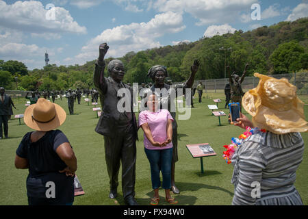 Pretoria, Südafrika, 20. Oktober, 2018. Frauen Besucher Bilder mit einer Skulptur von Walter und Nontsikelelo Albertina Sisulu, die ihren hundertsten Geburtstag gefeiert hätte, morgen, am 21. Oktober. Das Kunstwerk ist Teil des nationalen Erbes Denkmal, in der Groenkloof Pretoria Nature Reserve. Von Nelson Mandela, der sisulus führen "Der Marsch in die Freiheit flankiert," mit mehr als 50 lebensgrossen Skulpturen aus Bronze von Männern und Frauen, die sich für Südafrika der Befreiung von der Apartheid gekämpft. Eva-Lotta Jansson/Alamy leben Nachrichten Stockfoto