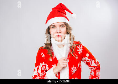 Weihnachten, Emotionen und Witz Begriff - Frau in Santa Kostüm mit falschen Bart betrachten sie ernst und wütend auf weißem Hintergrund mit Kopie Raum Stockfoto