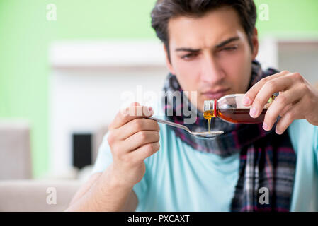 Jungen gutaussehenden Mann Leiden, Krankheit zu Hause Stockfoto