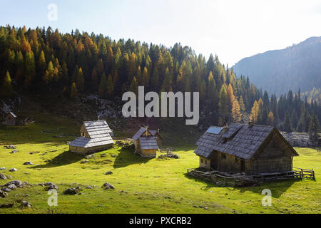 Bunte Bergwiese und Holzhütten im Herbst, Slowenien, Stockfoto