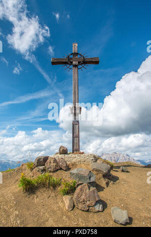 Gipfelkreuz, Kriegerdenkmal, hölzernes Kreuz auf der Spitze eines Berges in den italienischen Dolomiten. Herrliche Sommertag in den Bergen wandern. Stockfoto