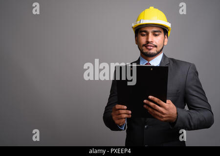 Die Jungen gut aussehenden bärtigen Persischen Geschäftsmann hardhat wieder tragen Stockfoto