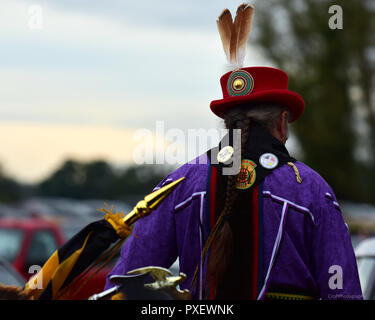 Native American gekleidet in traditionelle Kleidung und gefiederten Hut Stockfoto