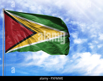 Nationalflagge von Guyana an einem Fahnenmast vor blauem Himmel. Stockfoto