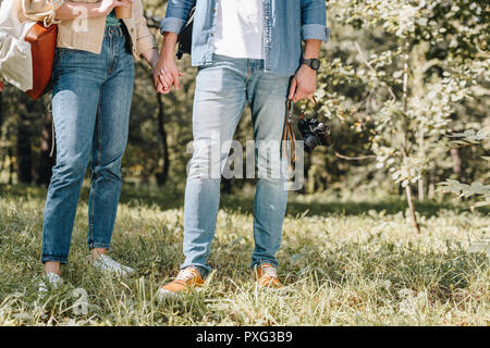 7/8 Schuß von Paar Hände halten in Park Stockfoto