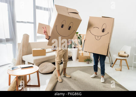 Verdeckt auf Paar mit Kartons auf Köpfe am neuen Haus, Umzug home Konzept Stockfoto