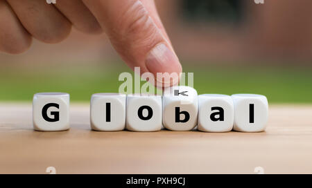 Hand dreht einen Würfel und Änderungen das Wort lokal bis global Stockfoto