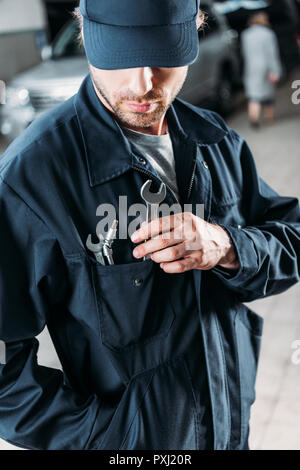 Handwerker in Gap und Overalls Werkzeuge in der Tasche Stockfoto