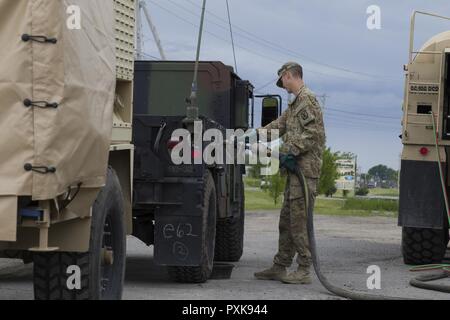 Us-Armee SPC. Leon Tore, Abteilung 1, Echo Company, 186th Brigade Support Battalion, 86th Infantry Brigade Combat Team (Berg), Vermont National Guard, Kraftstoffe ein Humvee in Malone, N.Y., 4. Juni 2017. Soldaten begleiten zu Fort Drum, N.Y., für eine Brigade warfighter Übung während der jährlichen Ausbildung. Stockfoto