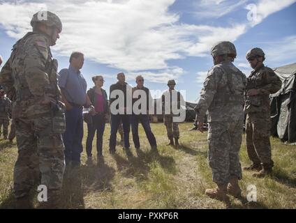 Us-Armee Generalmajor Timothy Reisch (links) der Adjutant General, South Dakota Army National Guard und die Mitglieder der South Dakota der militärischen Angelegenheiten, ein kurzer von Soldaten mit der 709Th Area Support Medical Unternehmen, Oklahoma Army National Guard, auf medizinische Operationen während des goldenen Coyote Übung an der Basis Custer, S.D., 15. Juni 2017. Die goldenen Coyote Übung ist eine dreiphasige, Szenario-driven Übung in den Black Hills von South Dakota und Wyoming, mit dem Kommandanten auf der Mission wesentliche Anforderungen der Aufgabe, Krieger Aufgaben und Übungen zu konzentrieren. Stockfoto