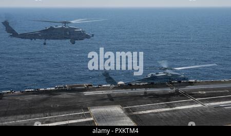 Mittelmeer (18. Juni 2017) eine doppelte Belichtung Foto von einem MH-60R Sea Hawk an Der partans" der Hubschrauber Maritime Strike Squadron (HSM) 70 Landung auf dem Flugdeck der Flugzeugträger USS George H.W. Bush (CVN 77) (GHWB) während des Flugbetriebs. GHWB, Teil der George H.W. Bush Carrier Strike Group (GHWBCSG), ist die Durchführung von naval Operations in den USA 6 Flotte Bereich der Maßnahmen zur Unterstützung der US-amerikanischen nationalen Sicherheitsinteressen in Europa und Afrika. Stockfoto