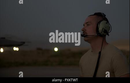 Senior Airman Kyle Bieri, 455Th Expeditionary Aircraft Maintenance Squadron Aerospace propulsion Techniker, kommuniziert mit einem Teammitglied bei einer F-16 Fighting Falcon Nachbrenner beim Flughafen Bagram, Afghanistan, 16. Juni 2017. Bieri ist aus Aviano Air Base, Italien bereitgestellt und unterstützt die F-16 Fighting Falcons auf die 36Th Expeditionary Jagdgeschwader zugeordnet. Stockfoto