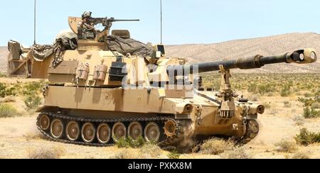 Soldaten mit Akku, 2d-Bataillon, 114 Field Artillery Regiment, Verlegung einer M109A6 Paladin Haubitze zu einem Schießplatz während des Bataillon live Fire Training Juni 7, 2017, in der National Training Center. (Mississippi Stockfoto