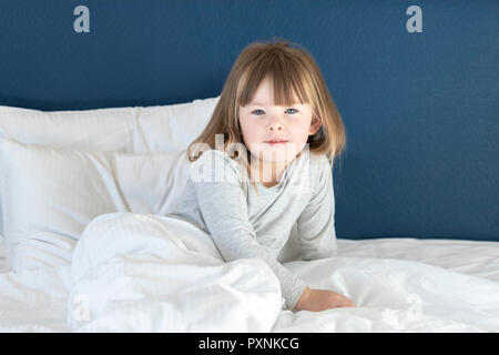 Adorable girl Stretching auf dem Bett Stockfoto