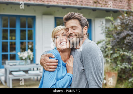 Glückliches Paar umarmen vor Ihren home Stockfoto