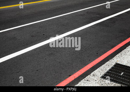 Autobahn signalisieren. Gelbe, Weiße und rote Linien über dunklen Asphalt Stockfoto