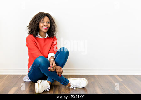 Schwarz afro-amerikanische sitzen auf dem Boden zu Hause Stockfoto